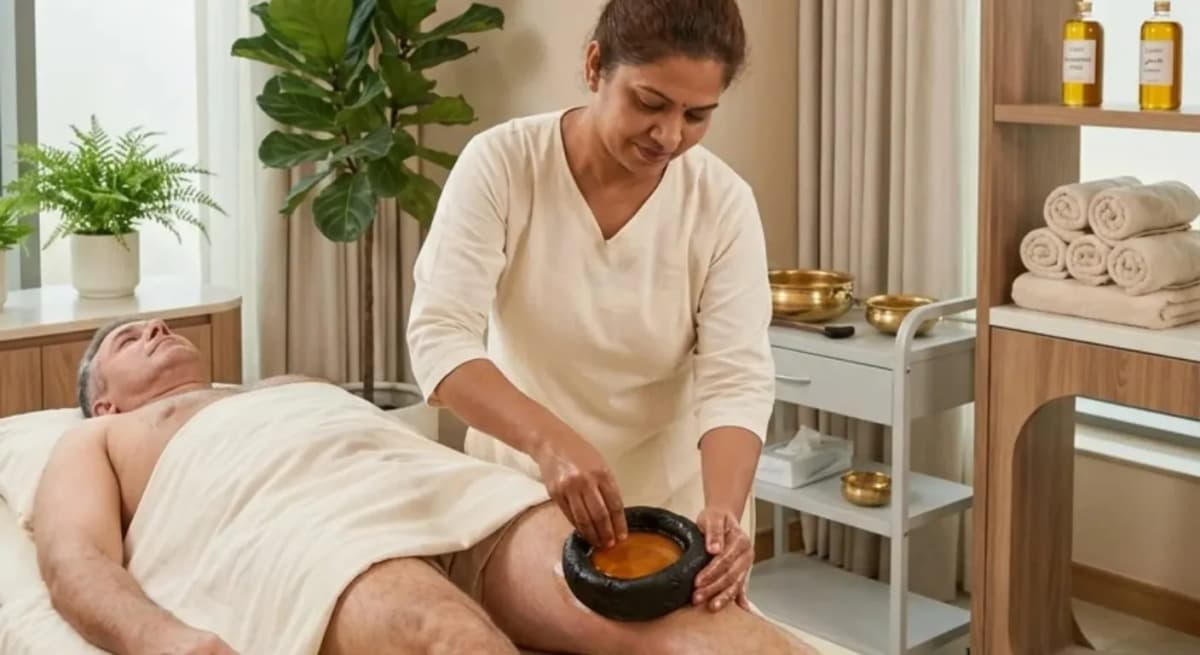 Ayurvedic doctor discussing knee symptoms with an adult patient during a consultation