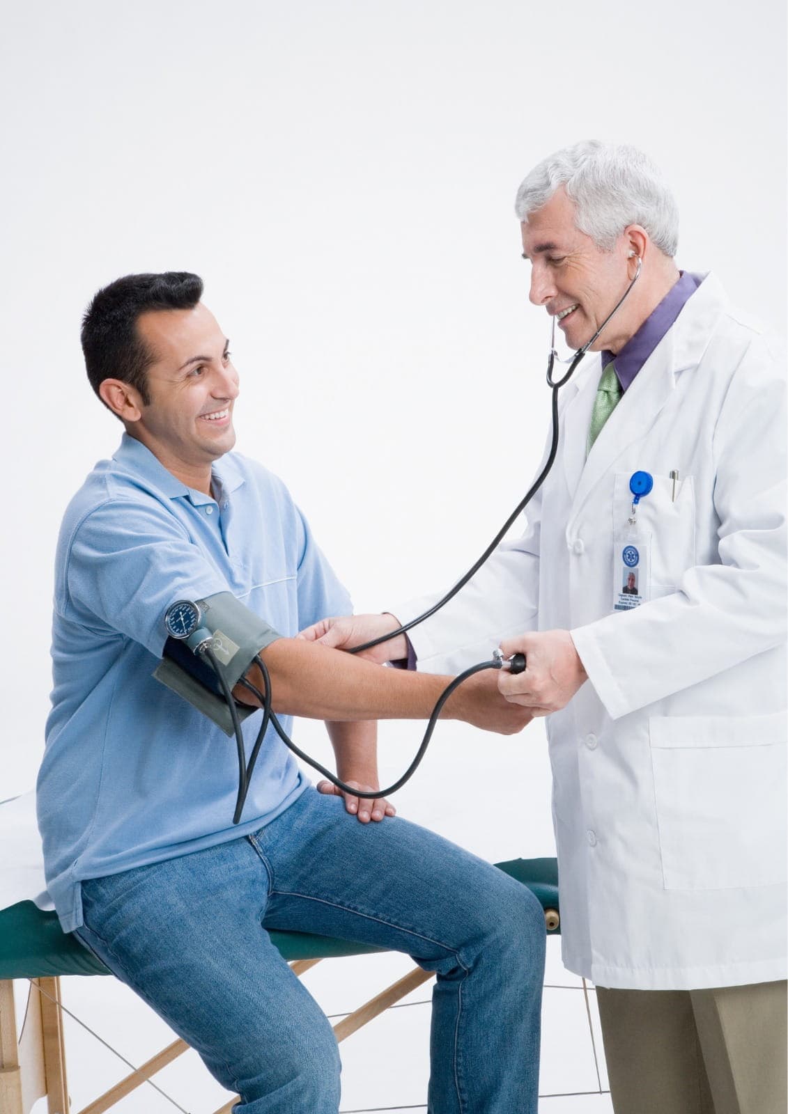 General physician measuring blood pressure and discussing hypertension management, modern clinical setting, no text in image