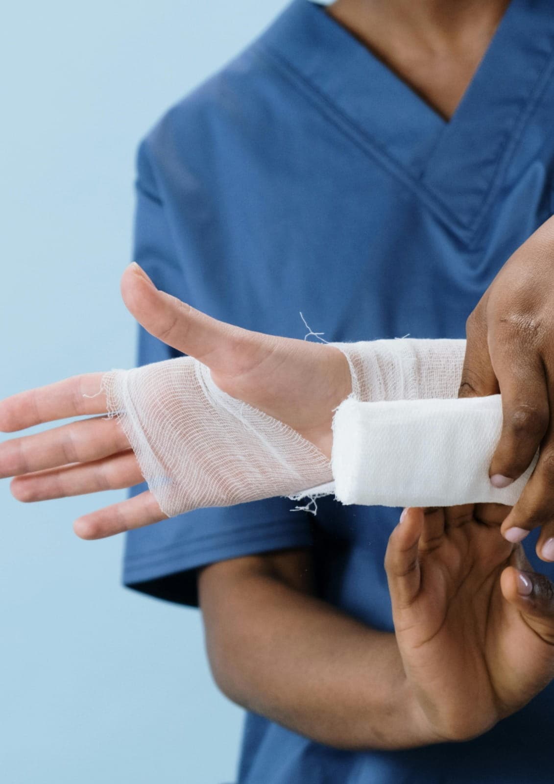 Doctor treating a minor injury with bandaging in a primary care clinic, patient comfort focused, realistic medical setting, no text