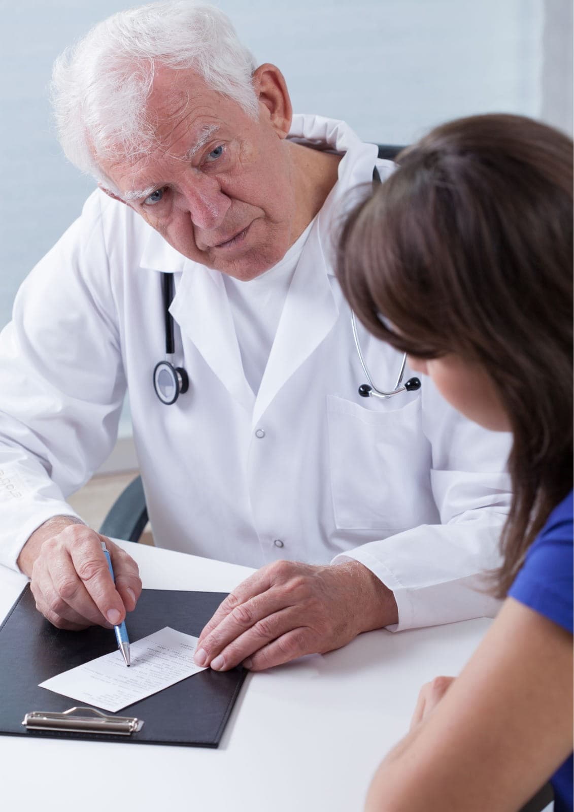 General physician performing a routine health checkup using a stethoscope, calm clinical room, patient-focused care, realistic medical photography, no text