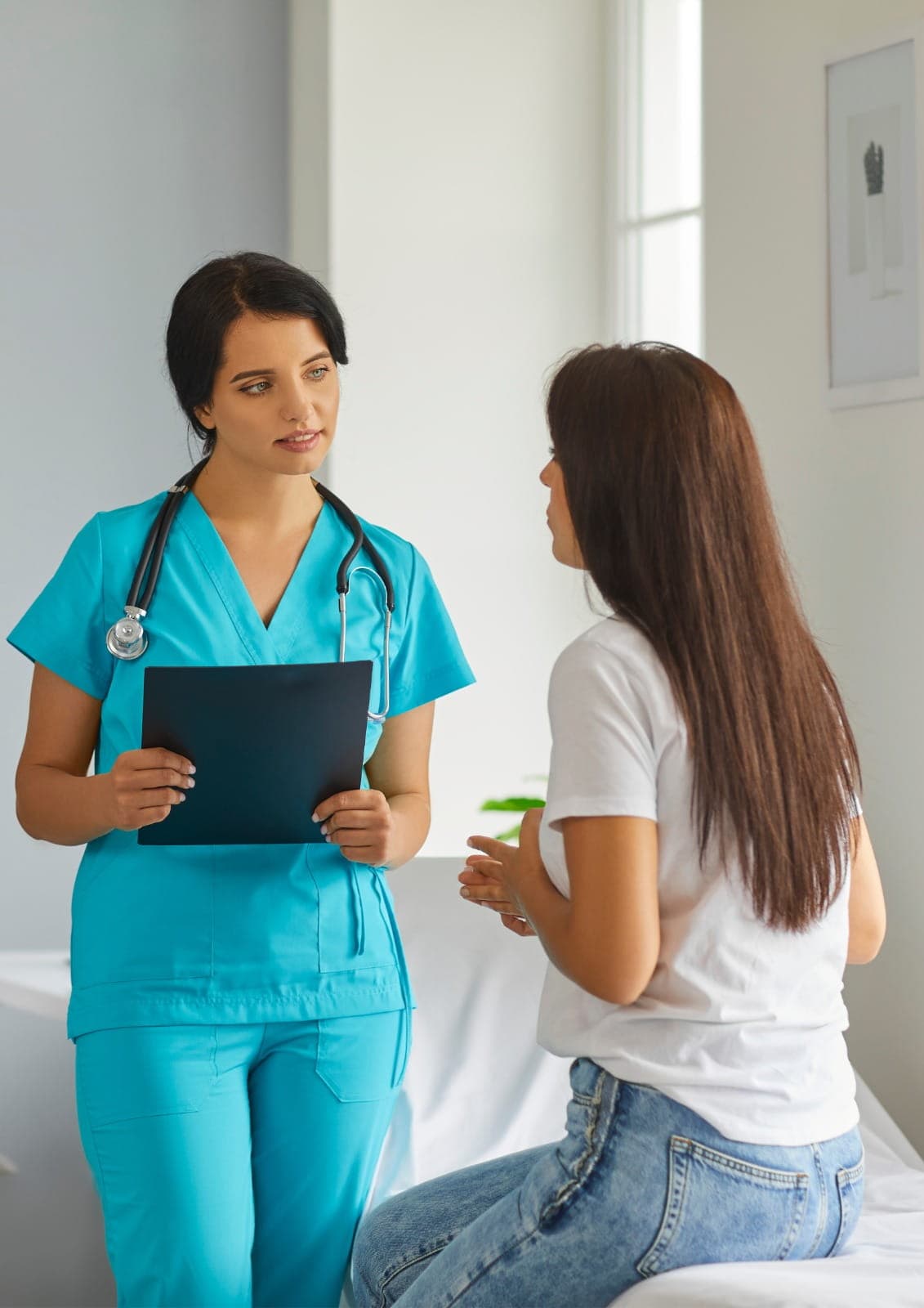 General physician performing a routine health checkup using a stethoscope, calm clinical room, patient-focused care, realistic medical photography, no text